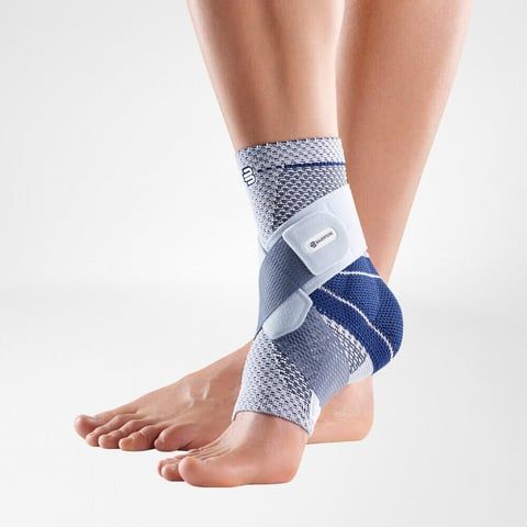 Model wearing the Bauerfeind MalleoTrain Plus Ankle Support while crossing feet