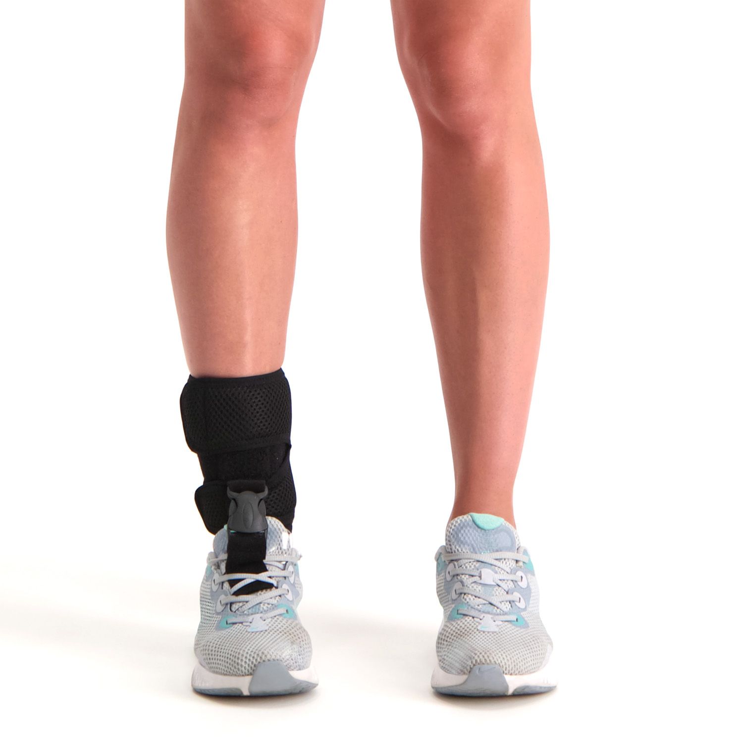 novamed foot up foot drop support worn by model around the right foot and ankle with sports shoes on shown from the front