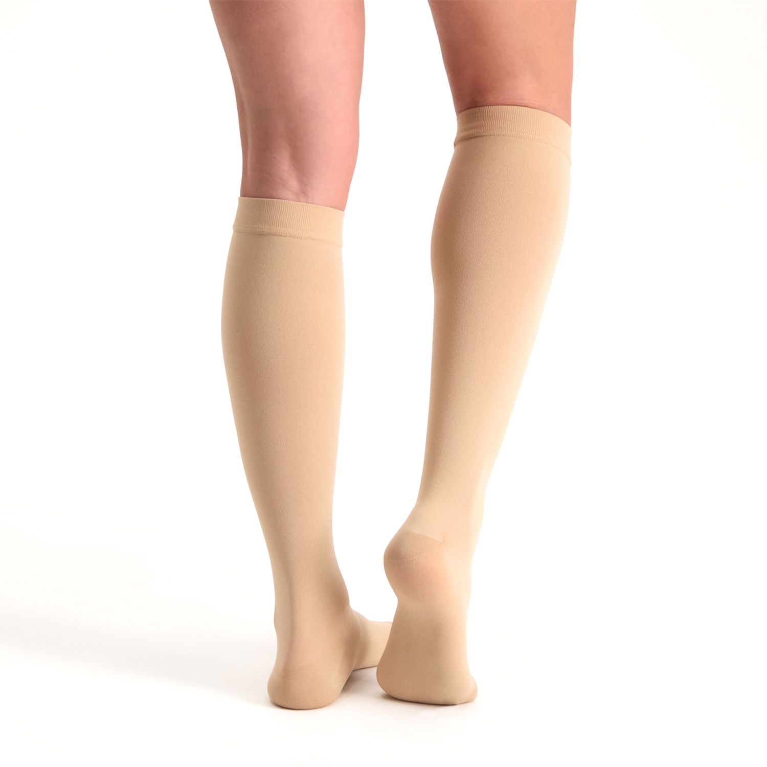 dunimed premium comfort compression stockings short closed in beige worn by model on both legs pictured from the back with the right leg lifted up