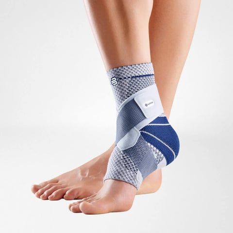 Model wearing the Bauerfeind MalleoTrain S Ankle Support while crossing feet