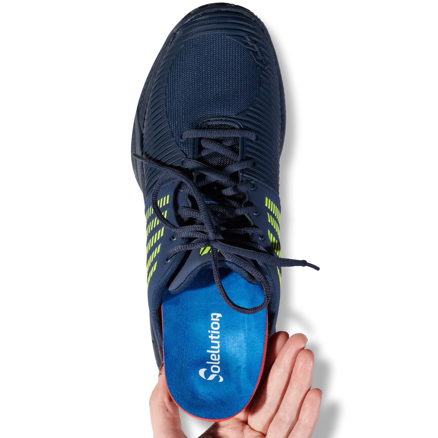 Solelution arch collapsed foot insoles being put in sporting shoes