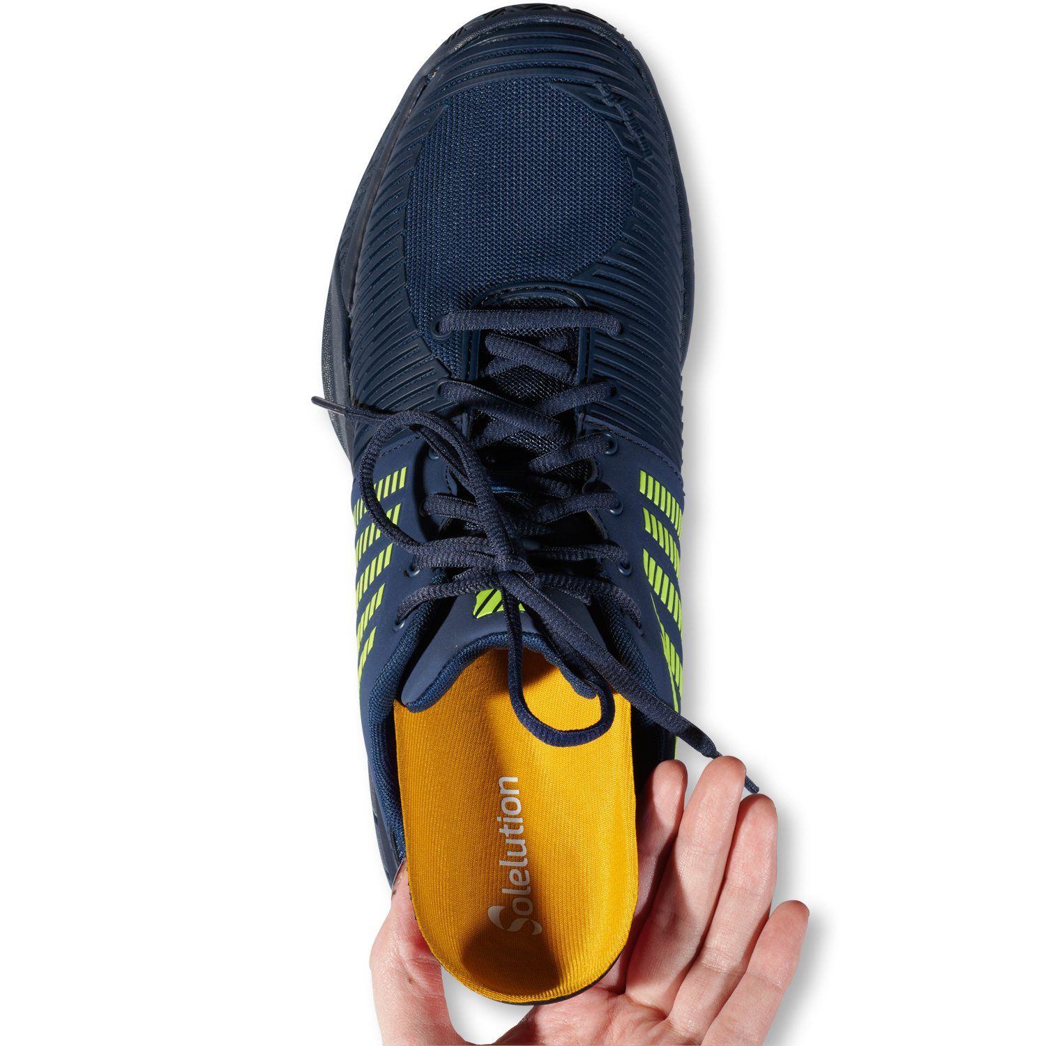 Solelution Overpronation Insoles being put in sports shoe