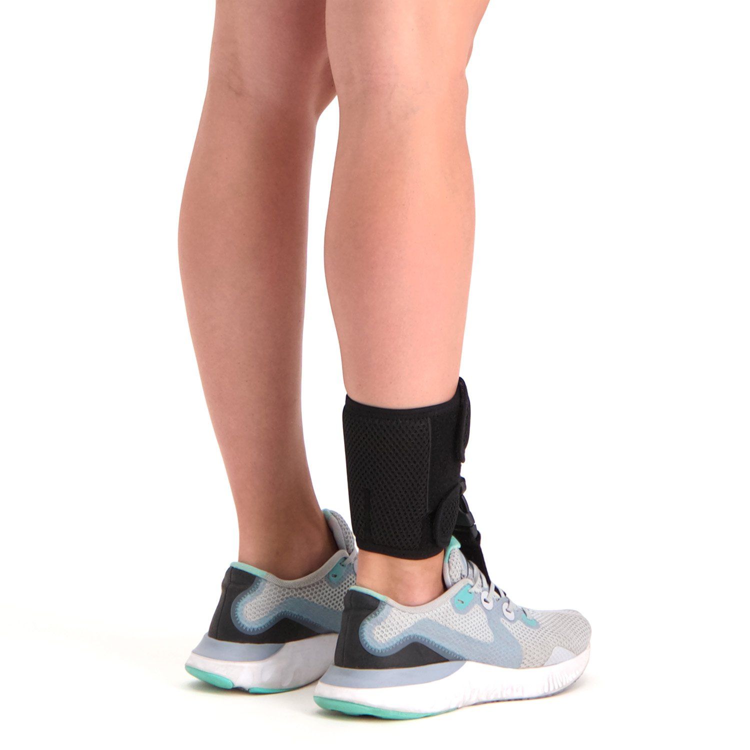 novamed foot up foot drop support worn by model around the right foot and ankle with sports shoes on shown from the back