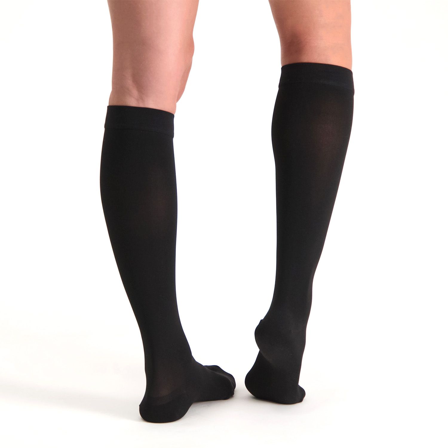 Dunimed Premium Comfort Compression Stockings Pressure Class 1 Closed Toe worn by model on both legs pictured from the back with the right foot lifted up