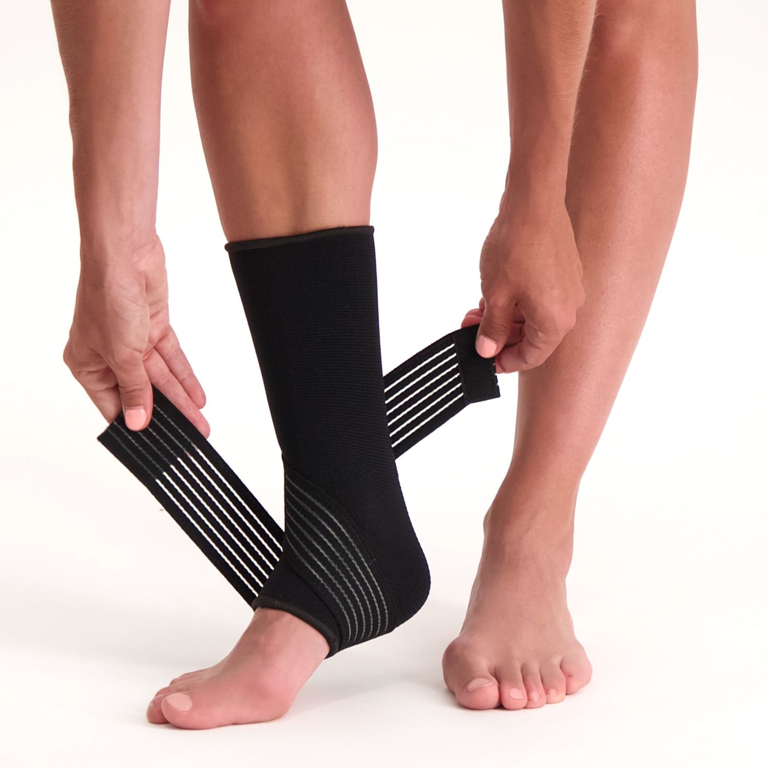 Model showing how to adjust the straps of the Dunimed Premium Ankle Support Black