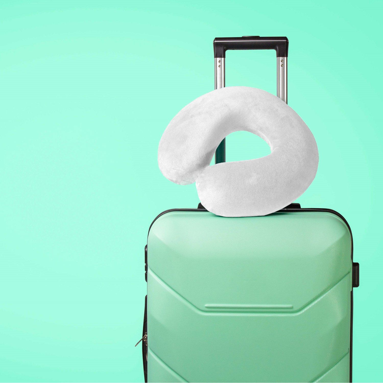 Novamed travel pillow in white on suitcase