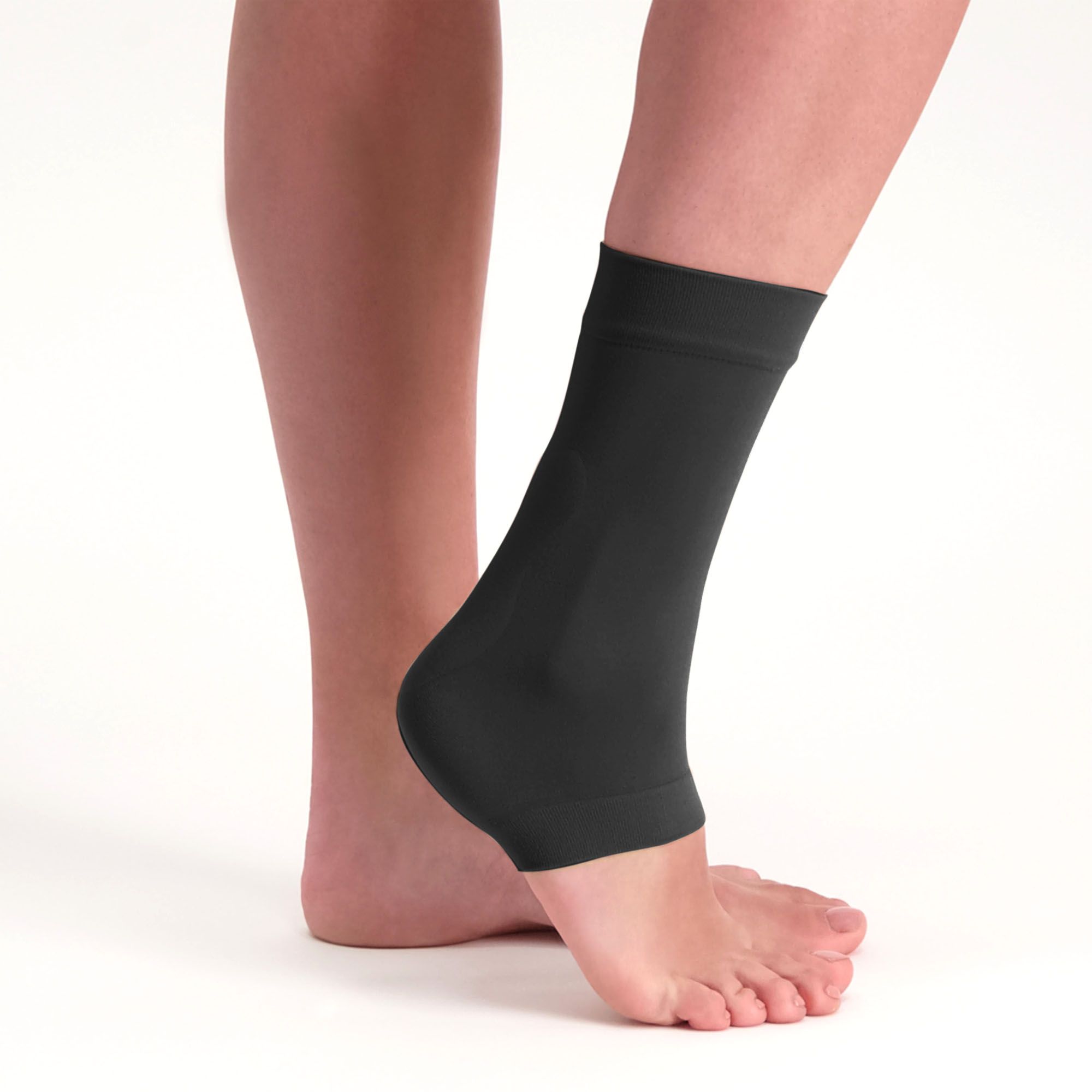 Solelution achilles tendon gel sock black worn by model on the right foot lifting the heel up shown from the side