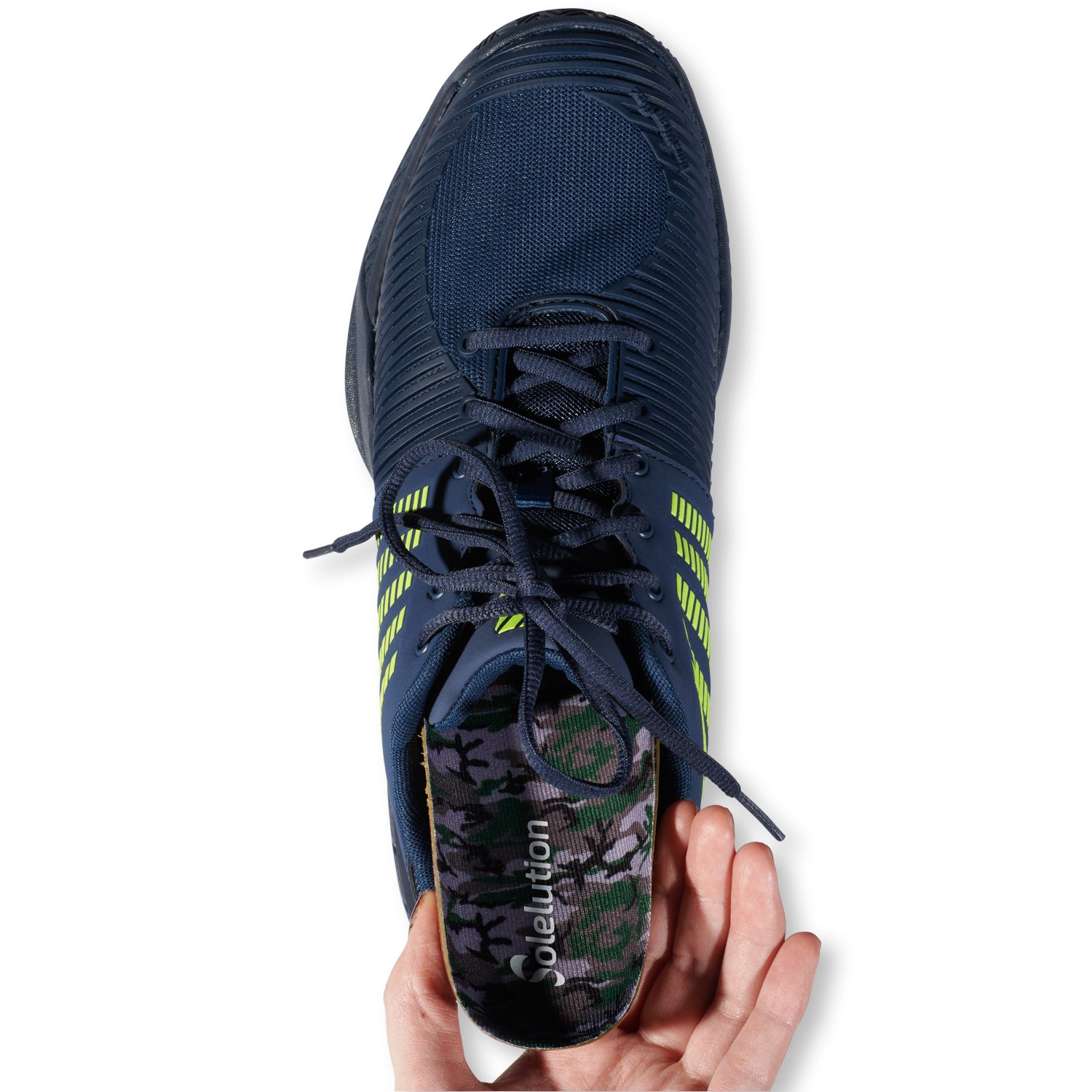 Placing the Solelution sport running insoles in a shoe