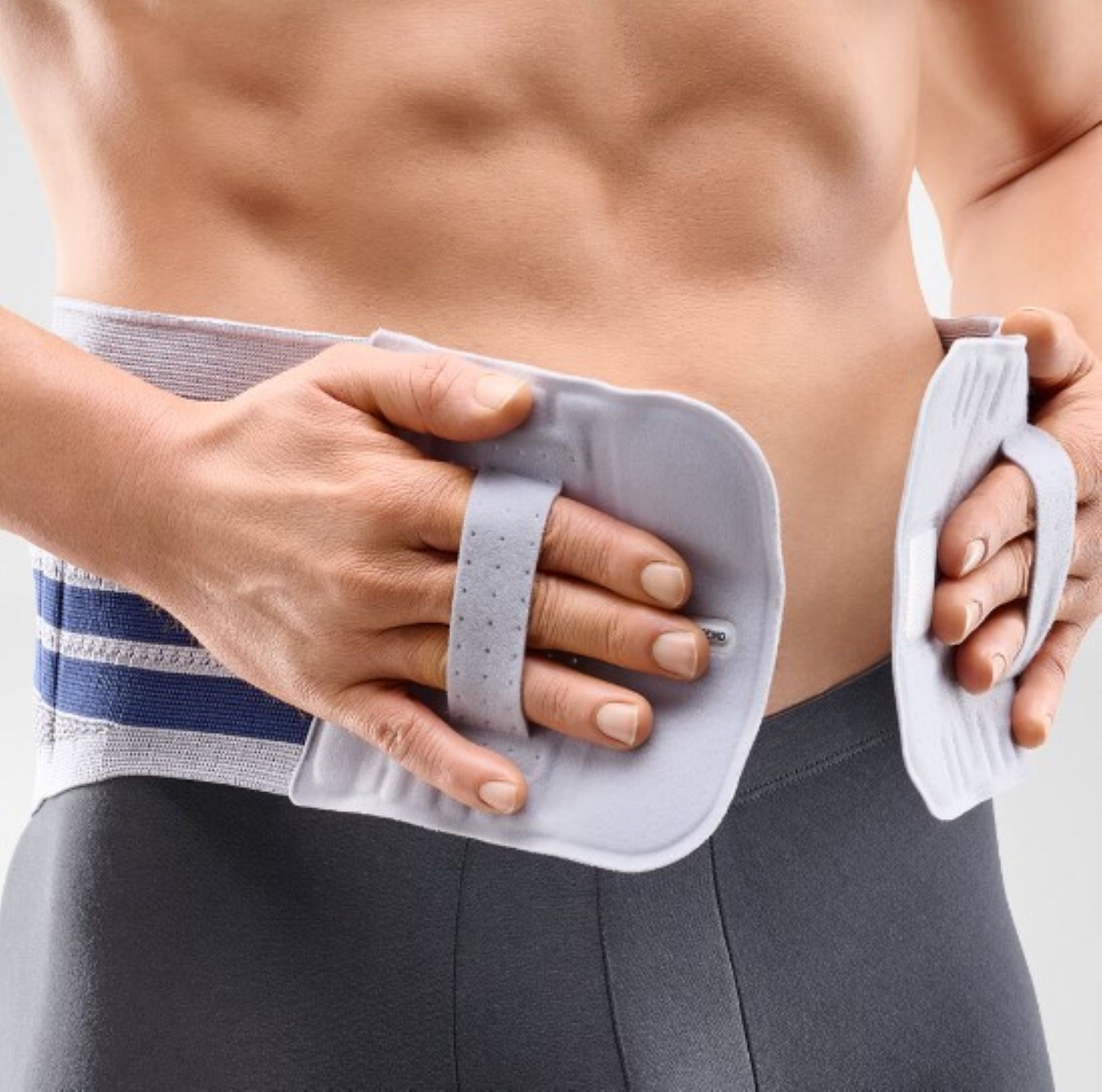 Model beim Anlegen der Bauerfeind Lumbotrain Straight Rückenbandage
