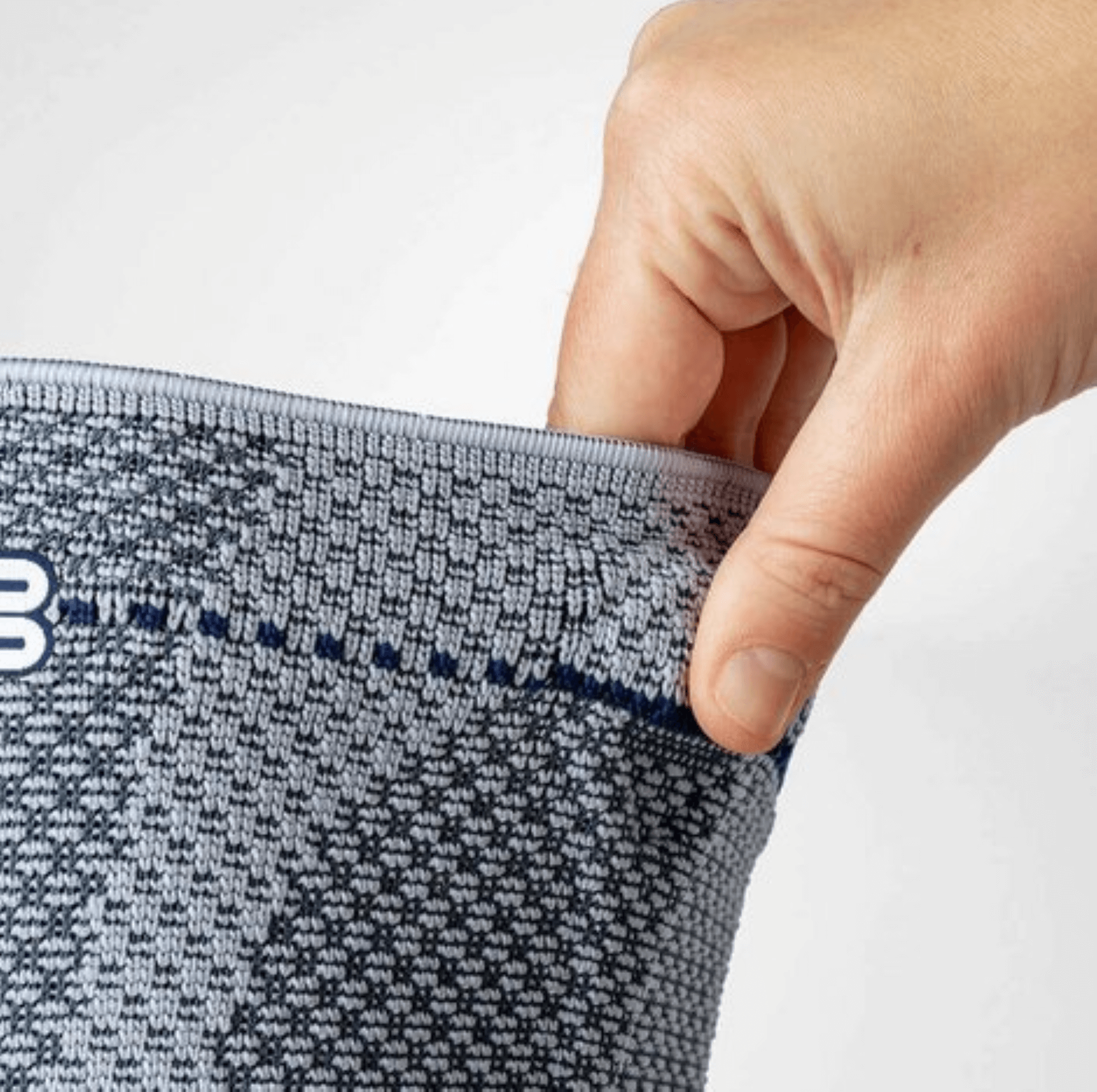Model hält den Verschluss der Bauerfeind GenuTrain A3 Kniebandage