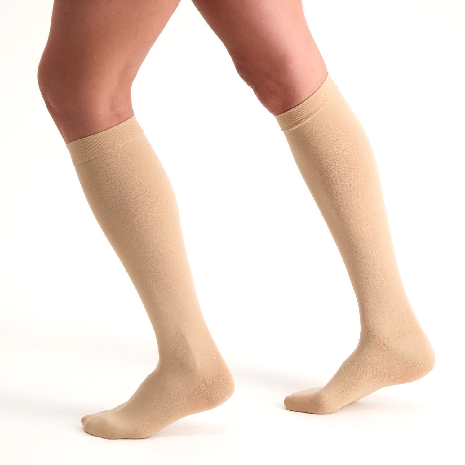 Model wearing the Dunimed Premium Comfort Compression Stockings Pressure Class 2 - Closed Toe in Beige while running
