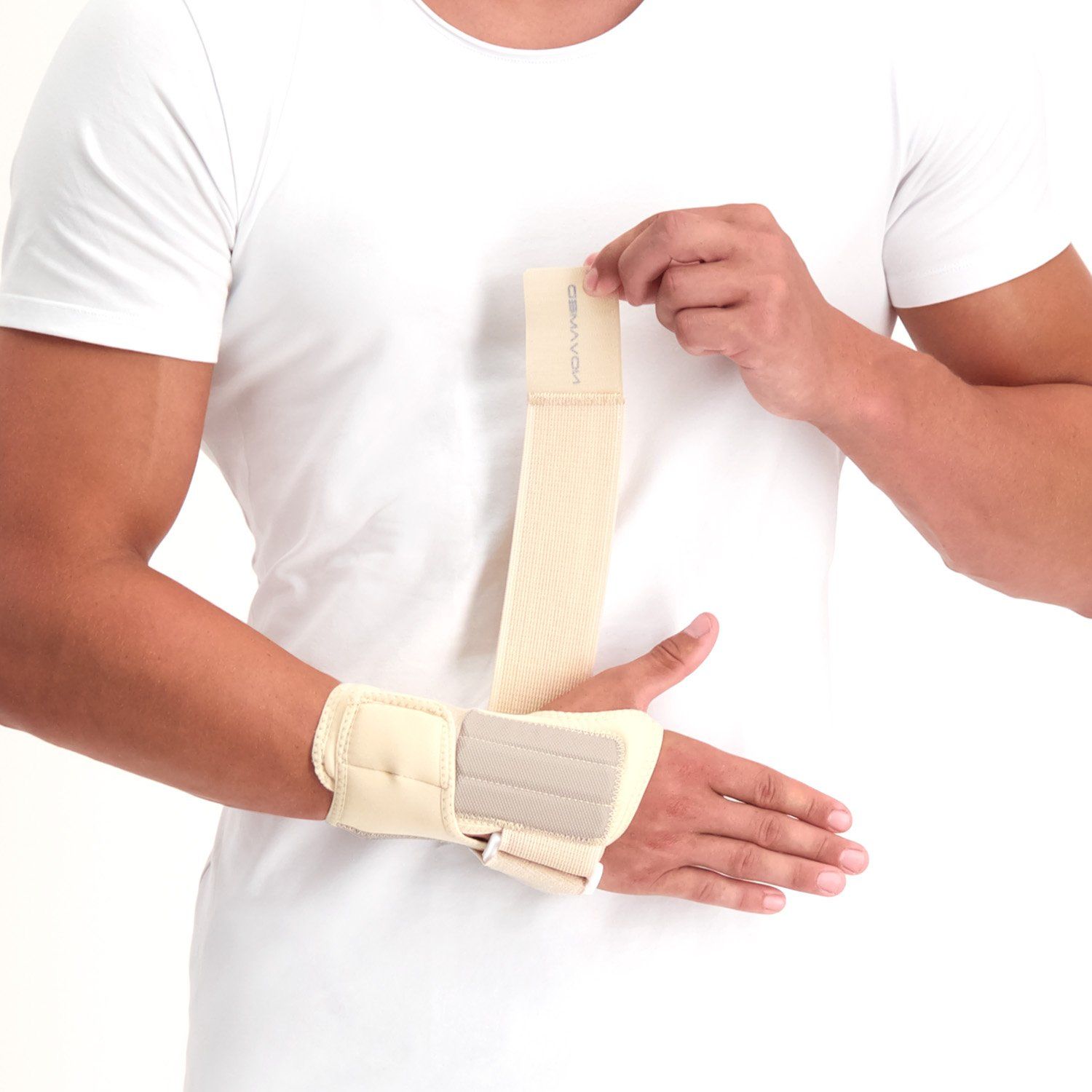 Front view of model strapping the Novamed Lightweight Wrist Support in Beige