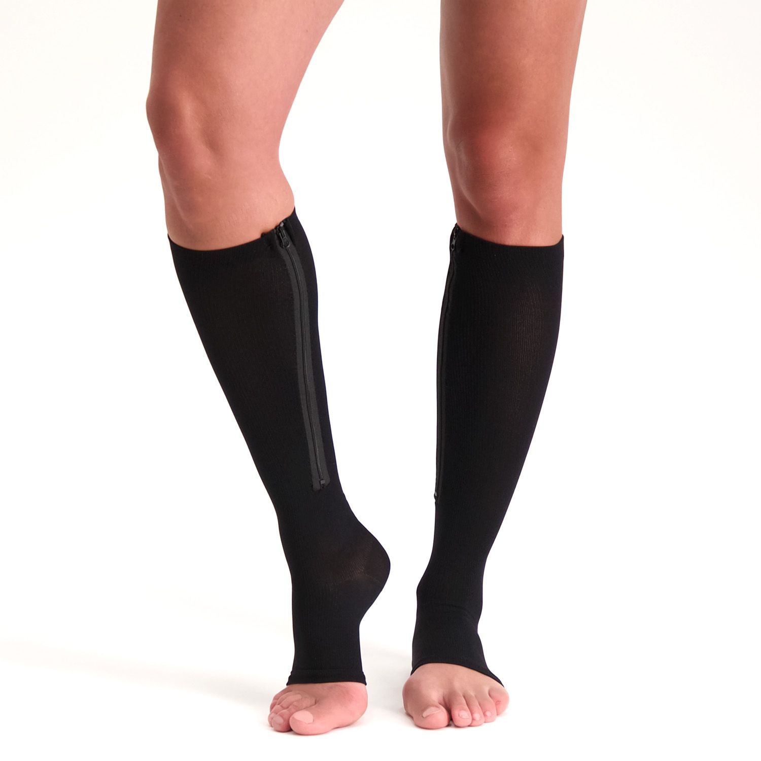 Front view of model wearing the Support Stockings with Zipper - Open Toe - Black on both legs while walking