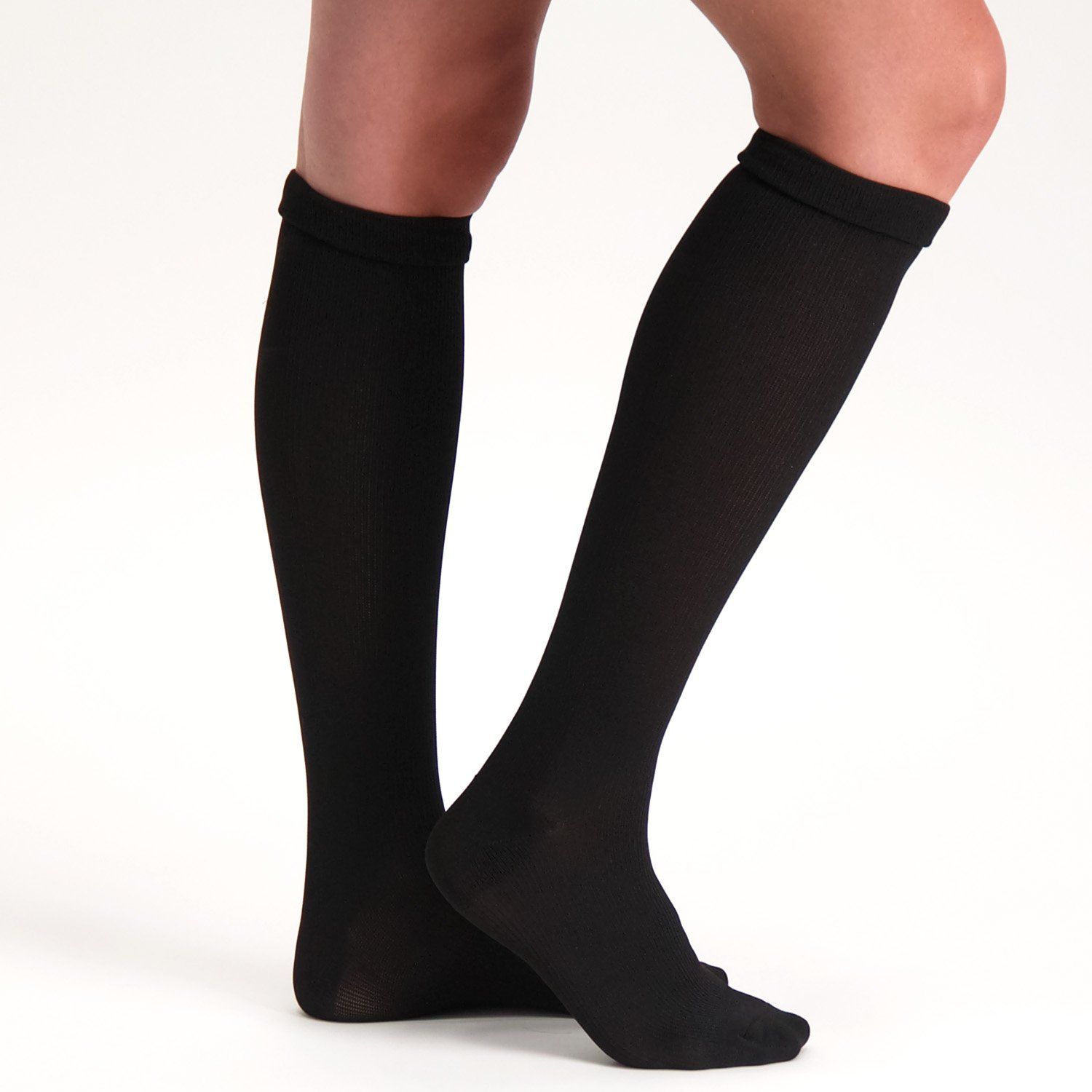 Side view of model wearing the Support Stockings / Travel Stockings - Closed Toe - Black