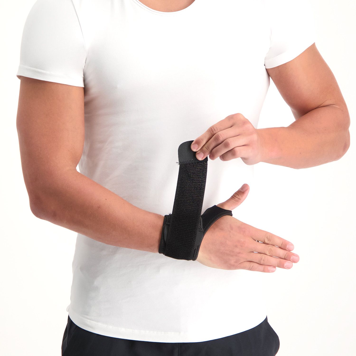 Model loosening the Velcro strap of the Dunimed Wrist Support