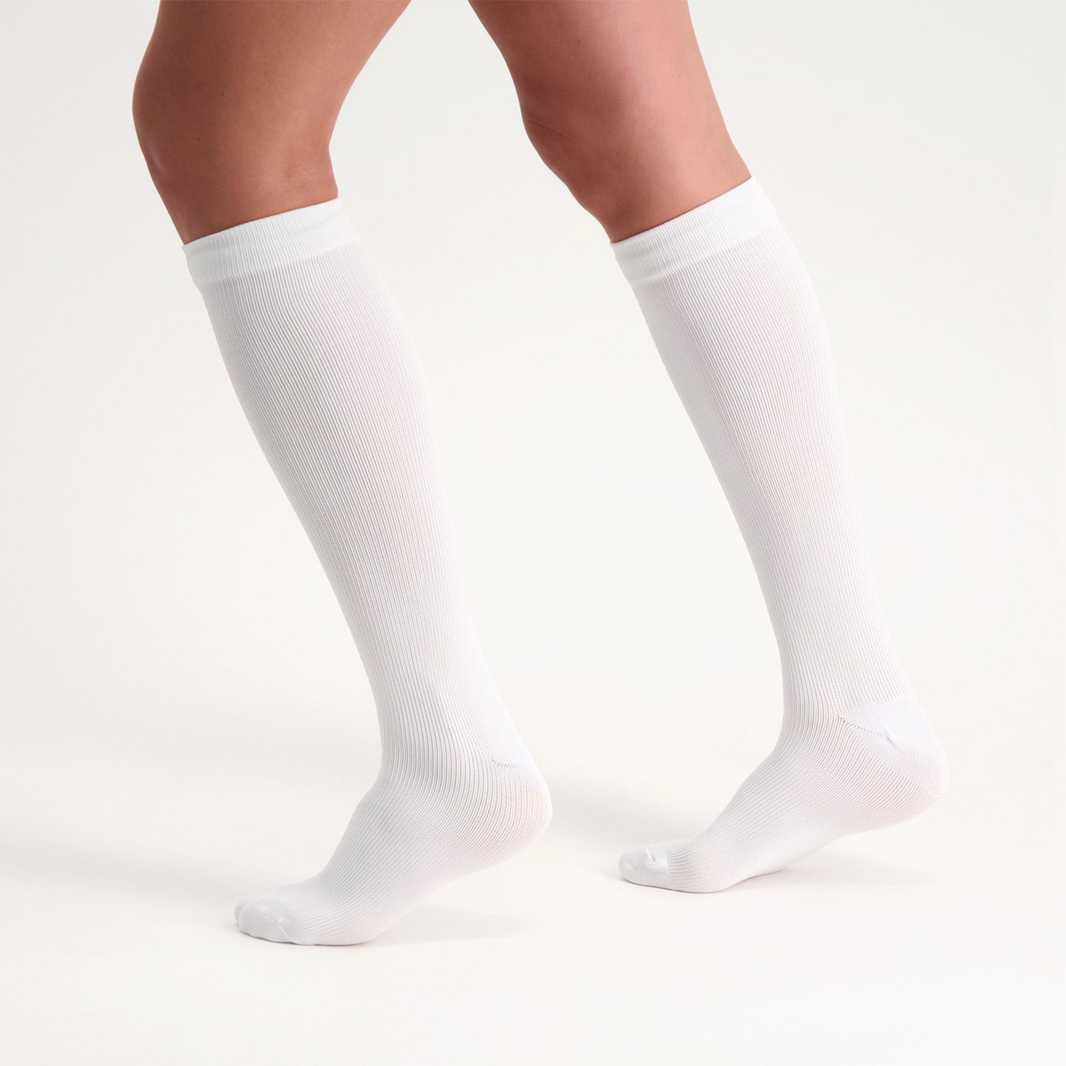 Side view of model wearing the Support Stockings / Travel Stockings - Closed Toe - White