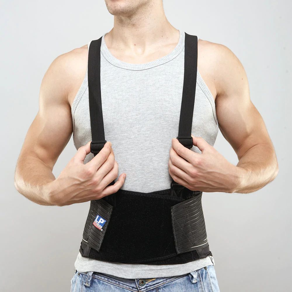 Front view of model wearing and holding the straps of the LP Support Industrial Back Support