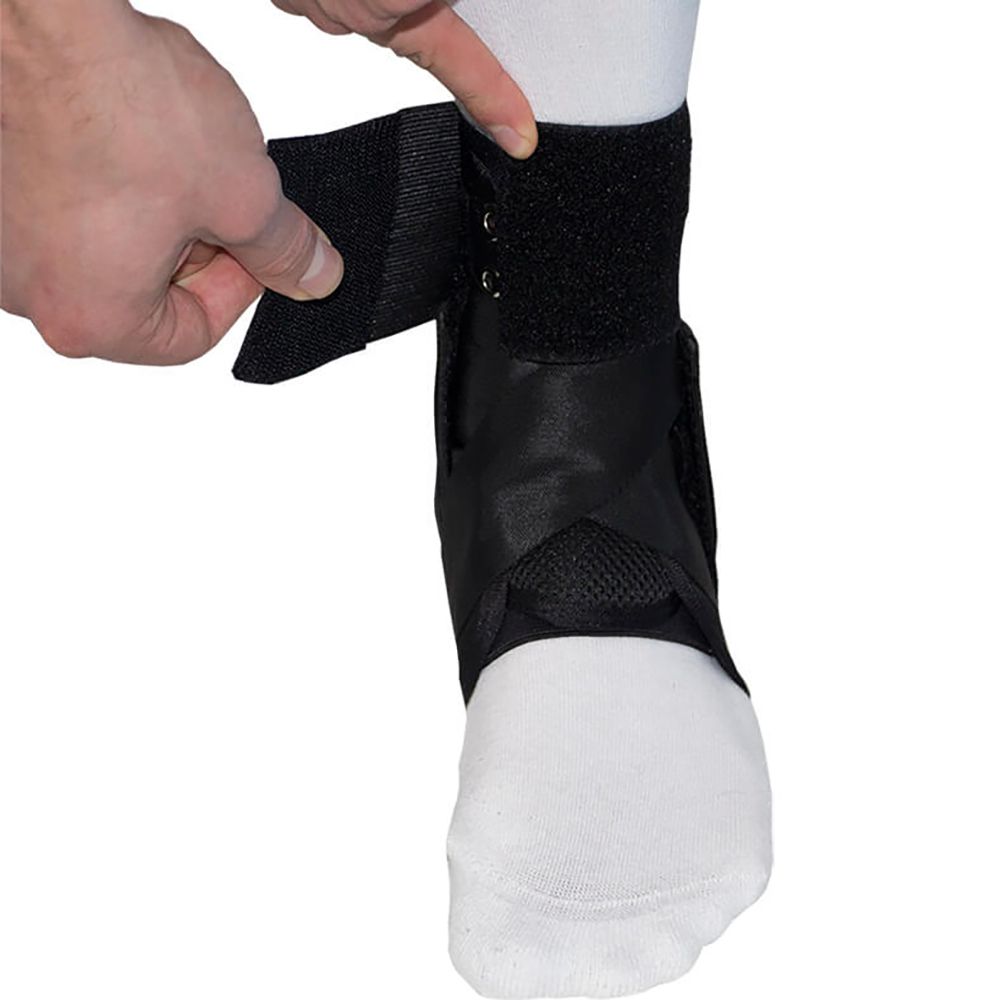 Ankle strap of the Gladiator Sports Lightweight Ankle Support with Straps being tightened