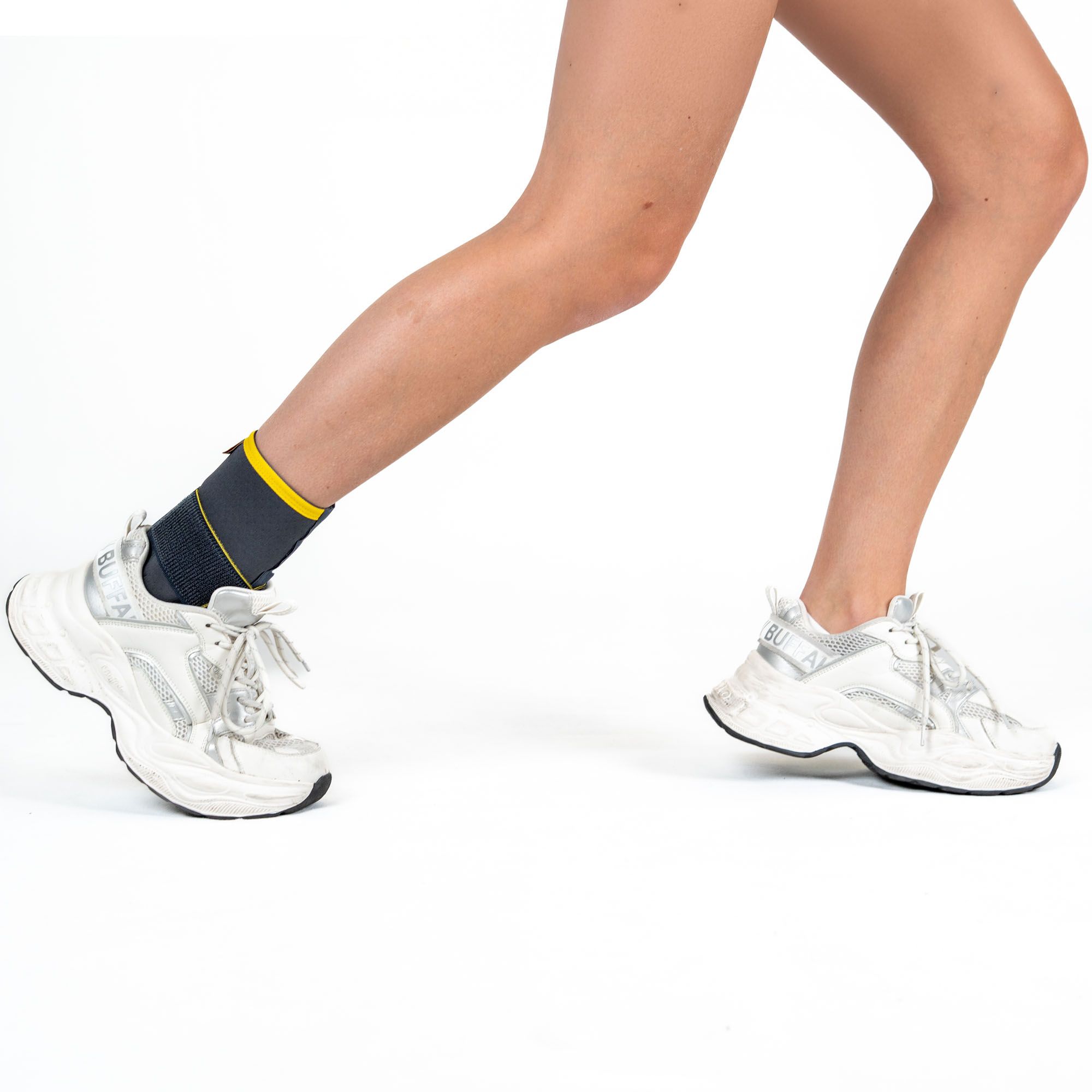 Right side view of model wearing the Morsa ThermoCY Lightweight Ankle Football Support in sports shoes while running