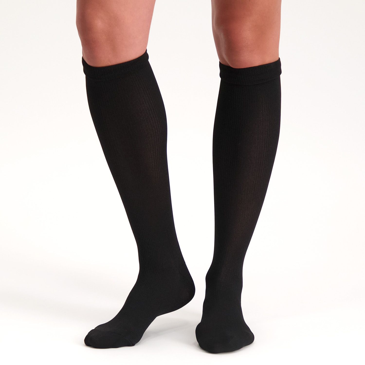 Front view of model wearing the Support Stockings / Travel Stockings - Closed Toe - Black while walking