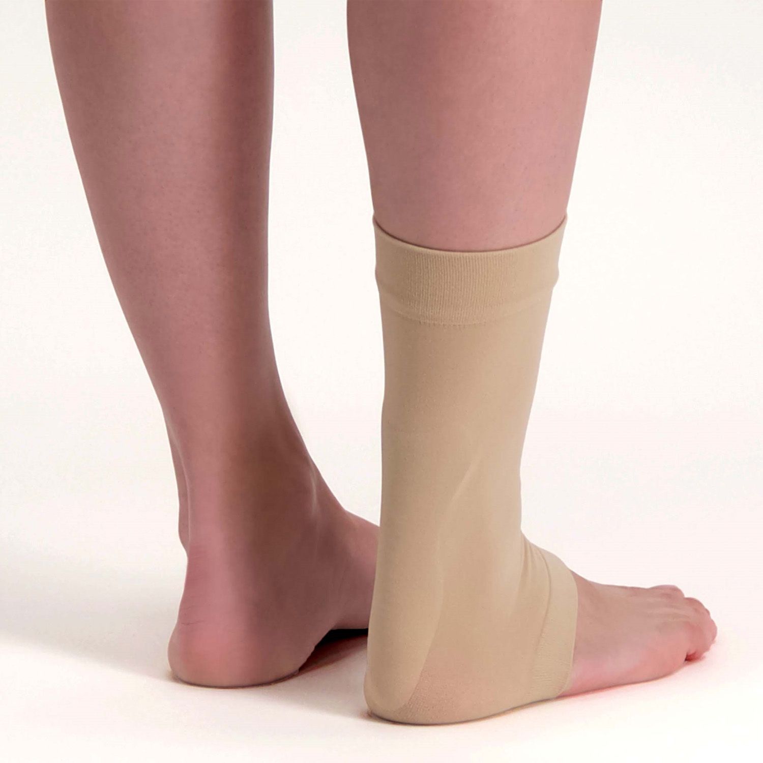 Back view of model wearing the Solelution Achilles Tendon Gel Sock - Beige around right ankle