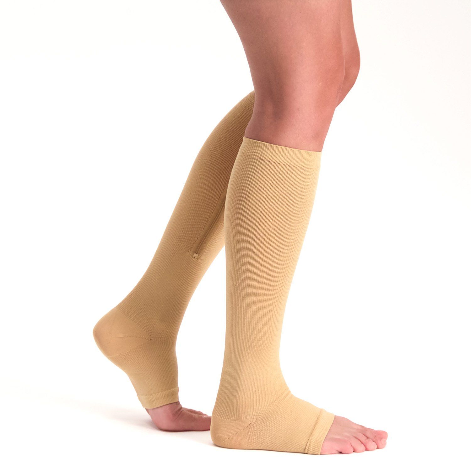 Side view of model wearing the Support Stockings with Zipper - Open Toe - Beige on both legs while walking