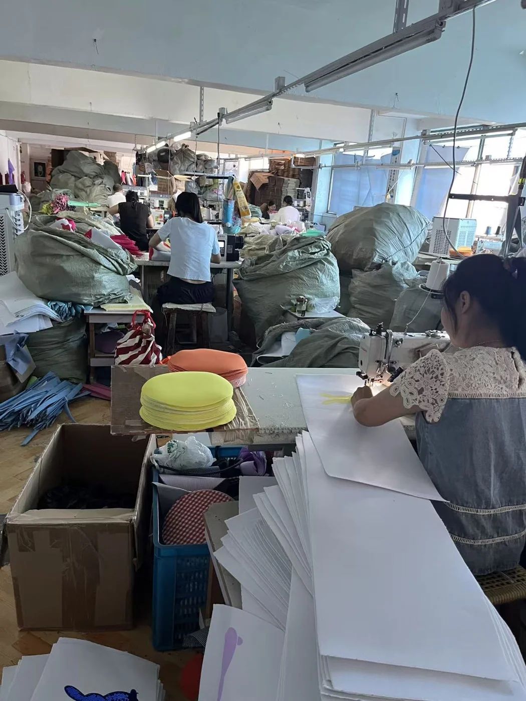 Holdfly Crafts workshop with staff sewing fabric holiday products