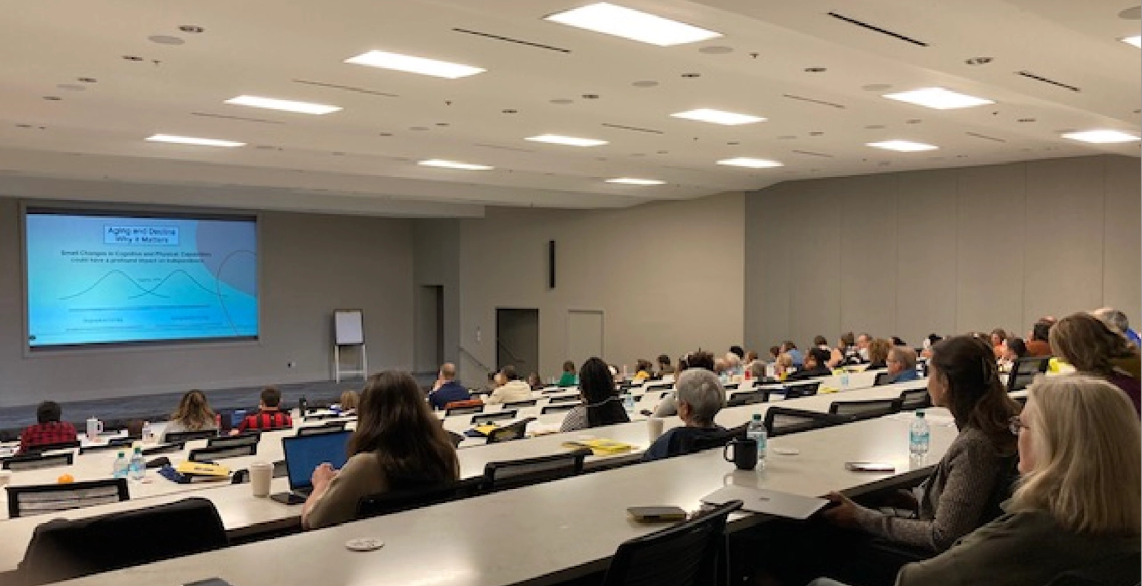 Attendees of the symposium watching a presentation