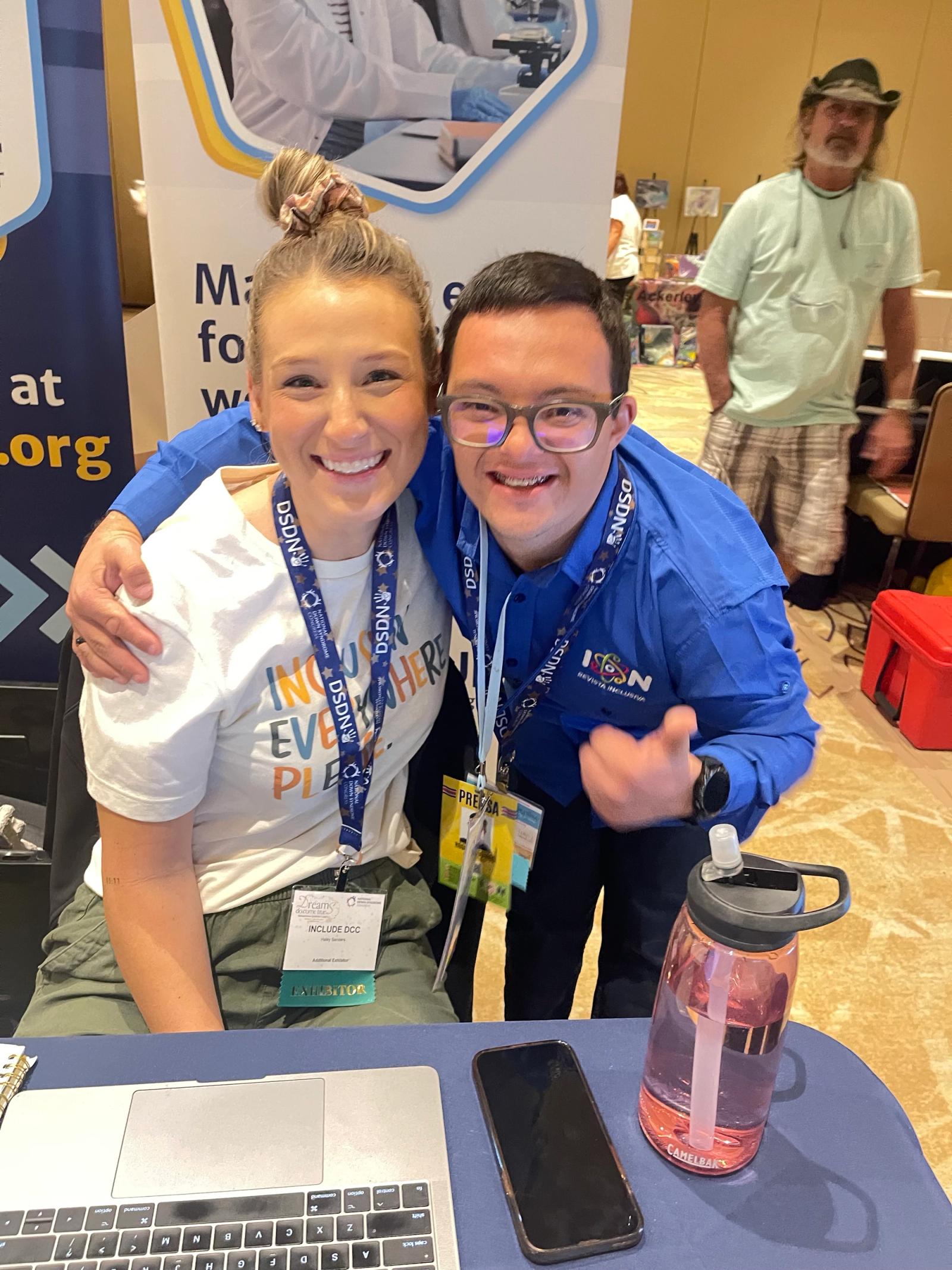 Image of INCLUDE DCC team member posing with self advocate at the INCLUDE DCC booth at the 2023 NDSC Annual Convention