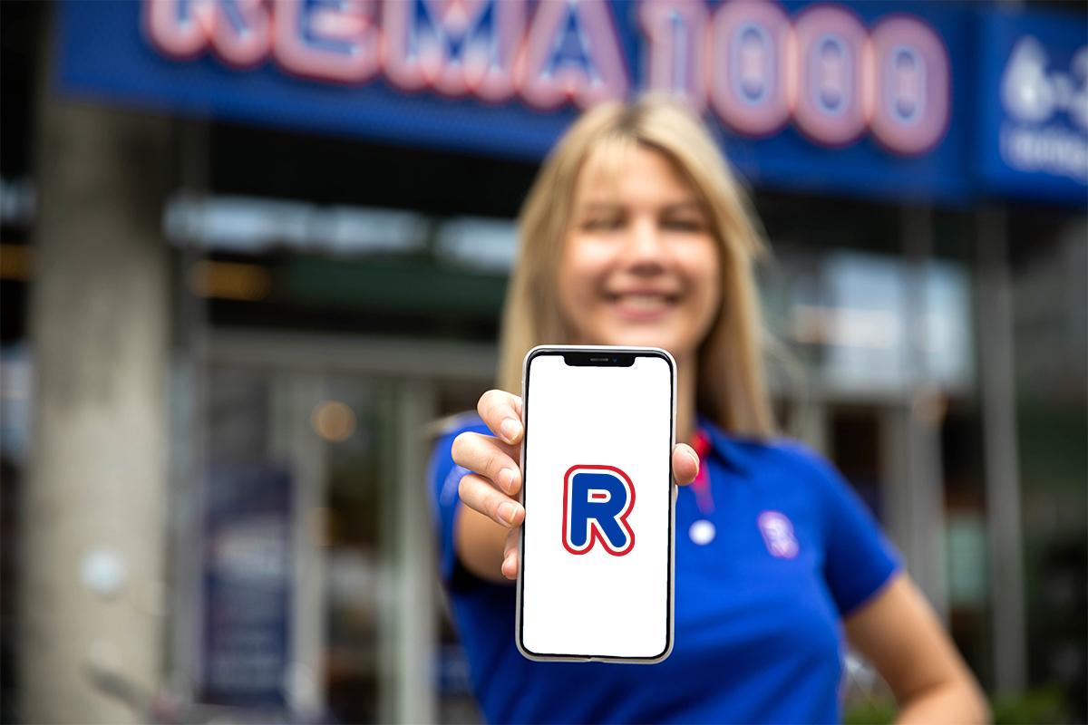 Dame som viser frem mobilen din med REMA-appen