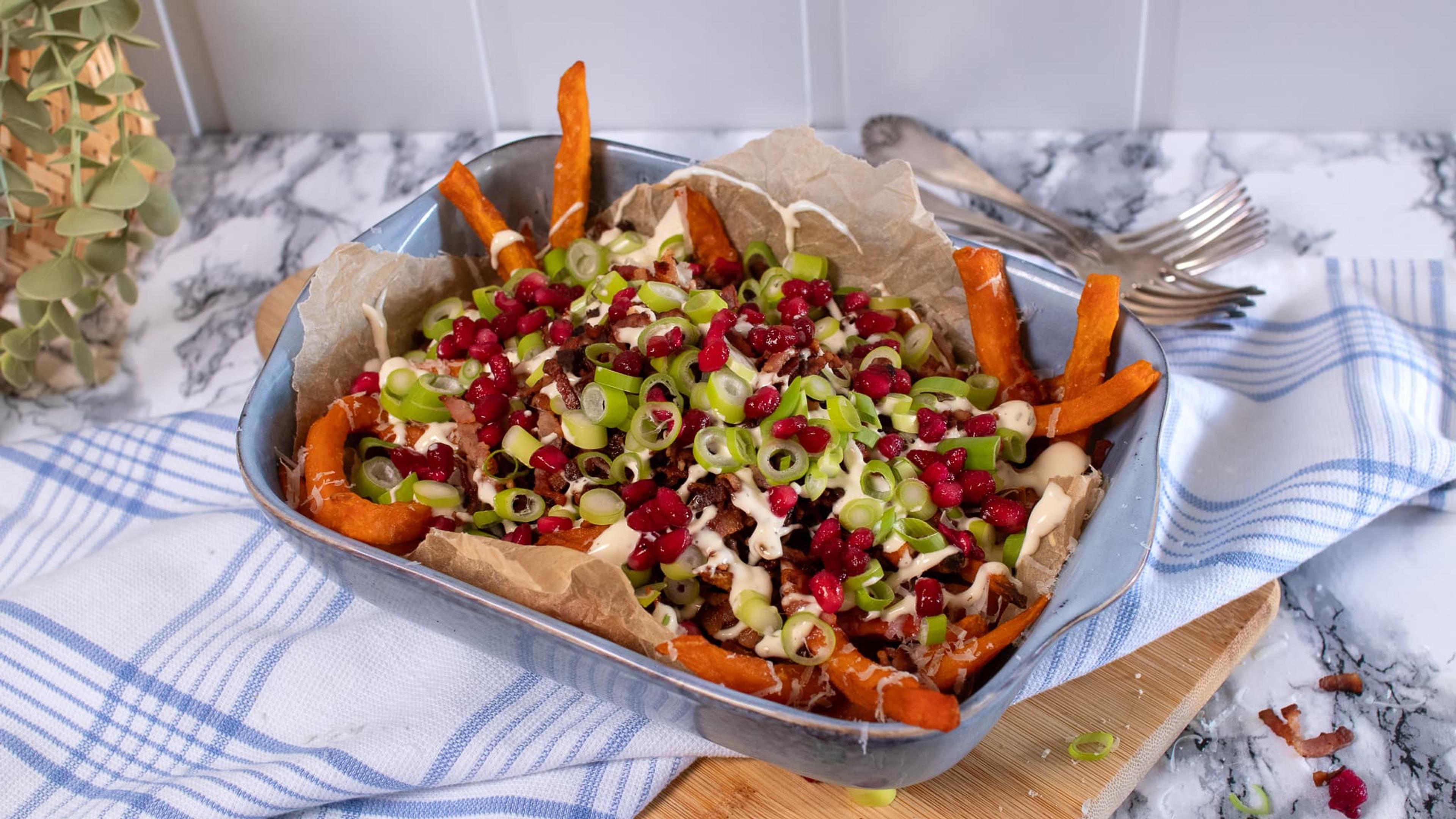 Dirty søtpotetfries med topping, servert i form.