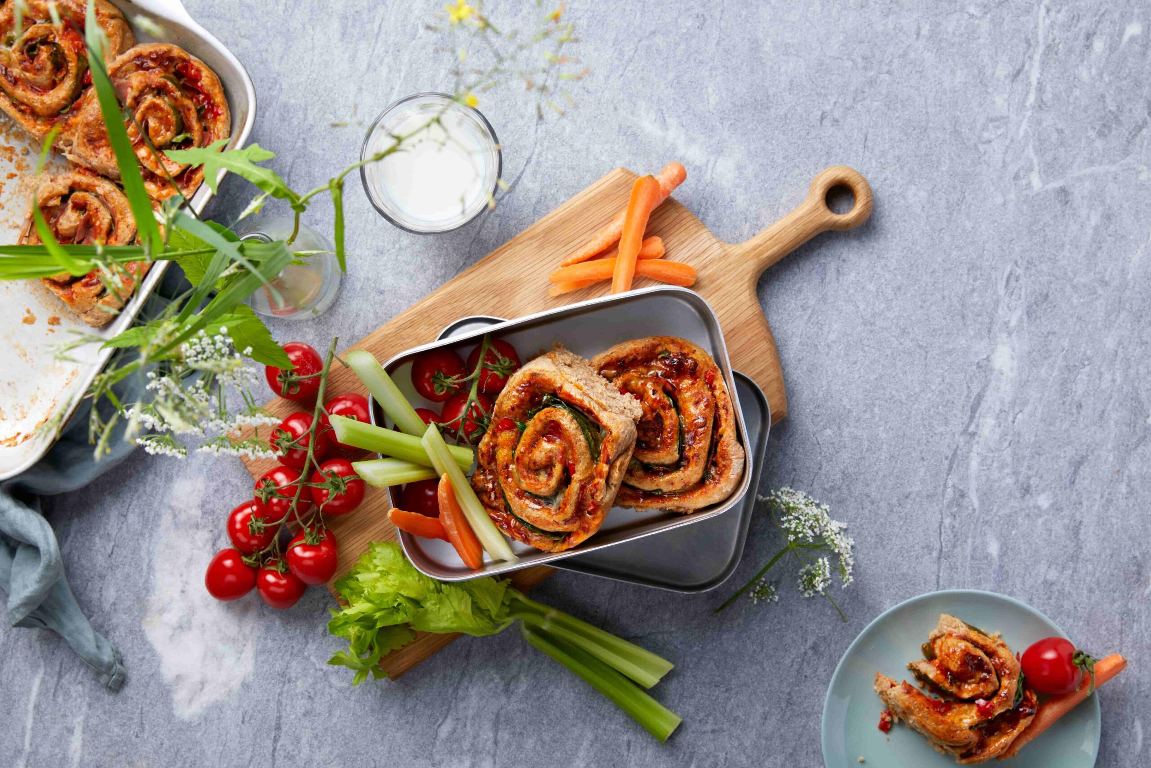 Bilde av pizzasnurrer og tomater i en matboks