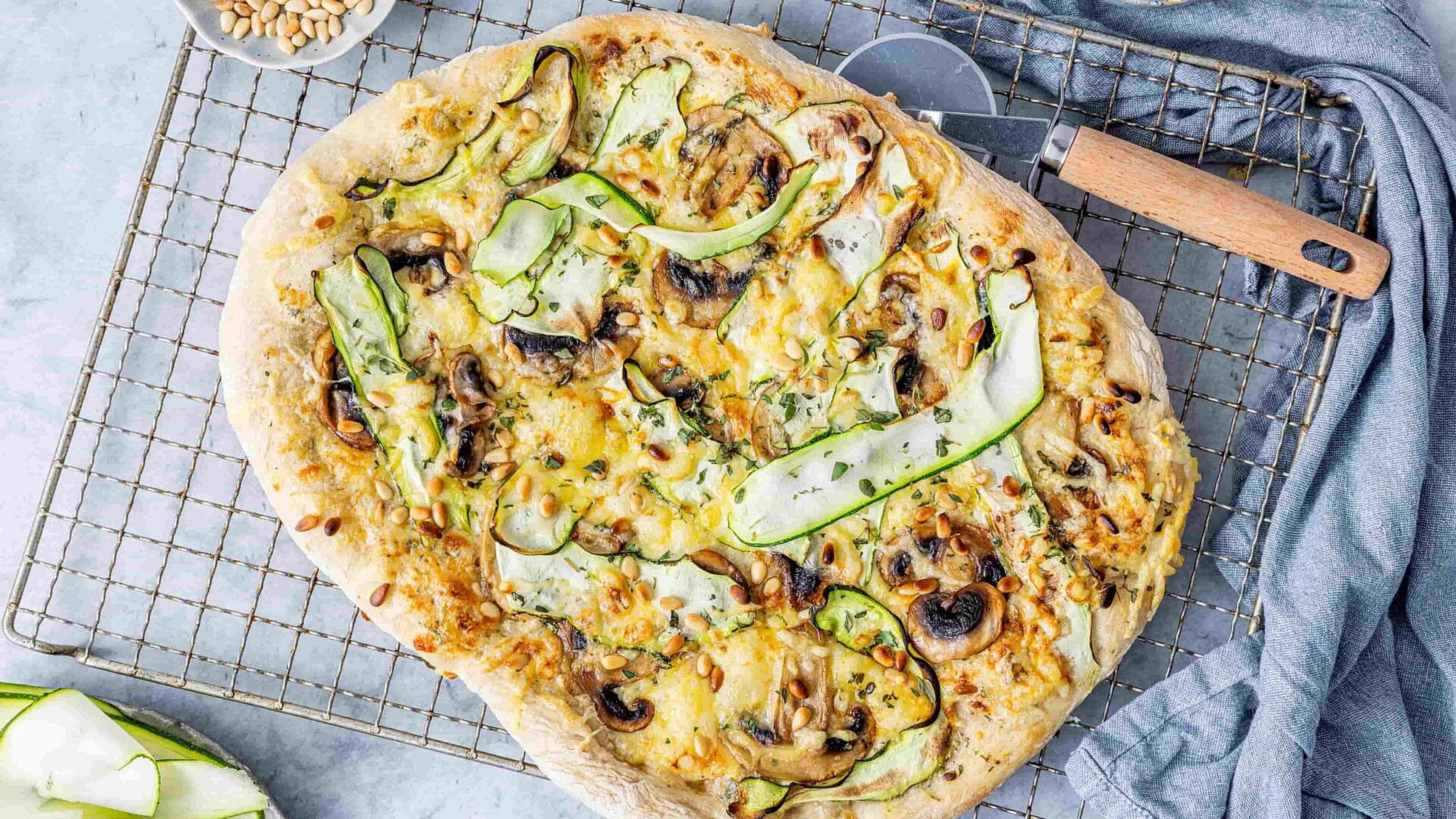 Dekkebord med tallerkener, glass, lysestaker og høstpynt i varme farger.