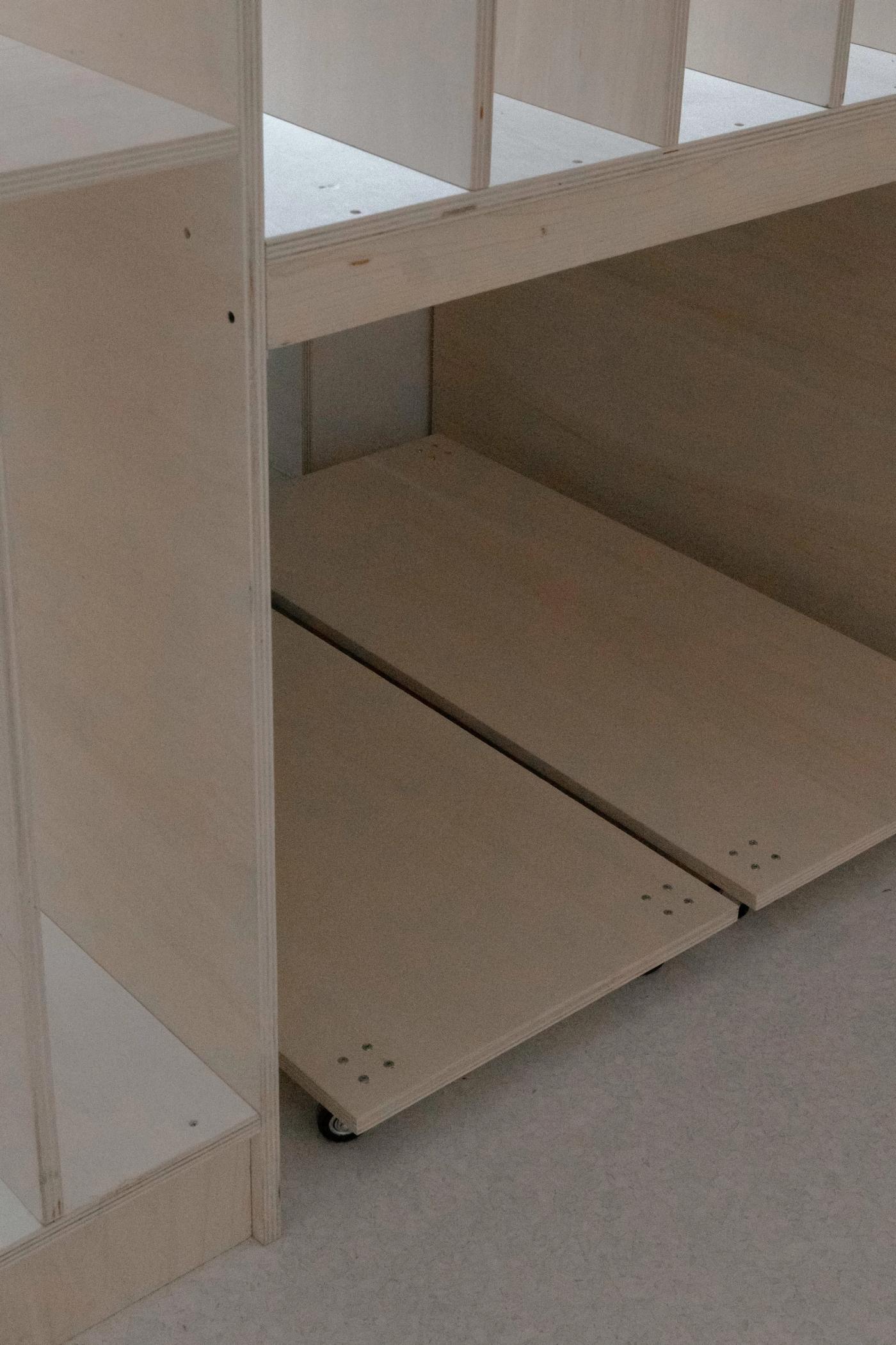 Dettaglio di mobile con ripiani e sportelli in legno naturale, produzione Loreti e Sibilla falegnameria d'autore.