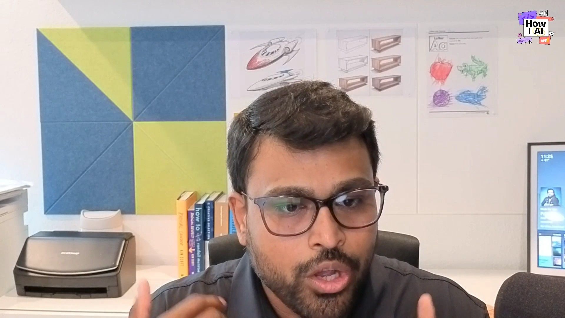 Anjan discusses design concepts during a meeting, with relevant sketches and materials visible in the background.