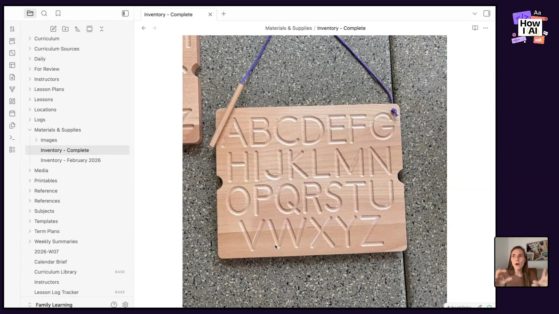 A detailed view of an 'Inventory - Complete' page within a knowledge management application, showcasing a wooden alphabet tracing board used for educational purposes.