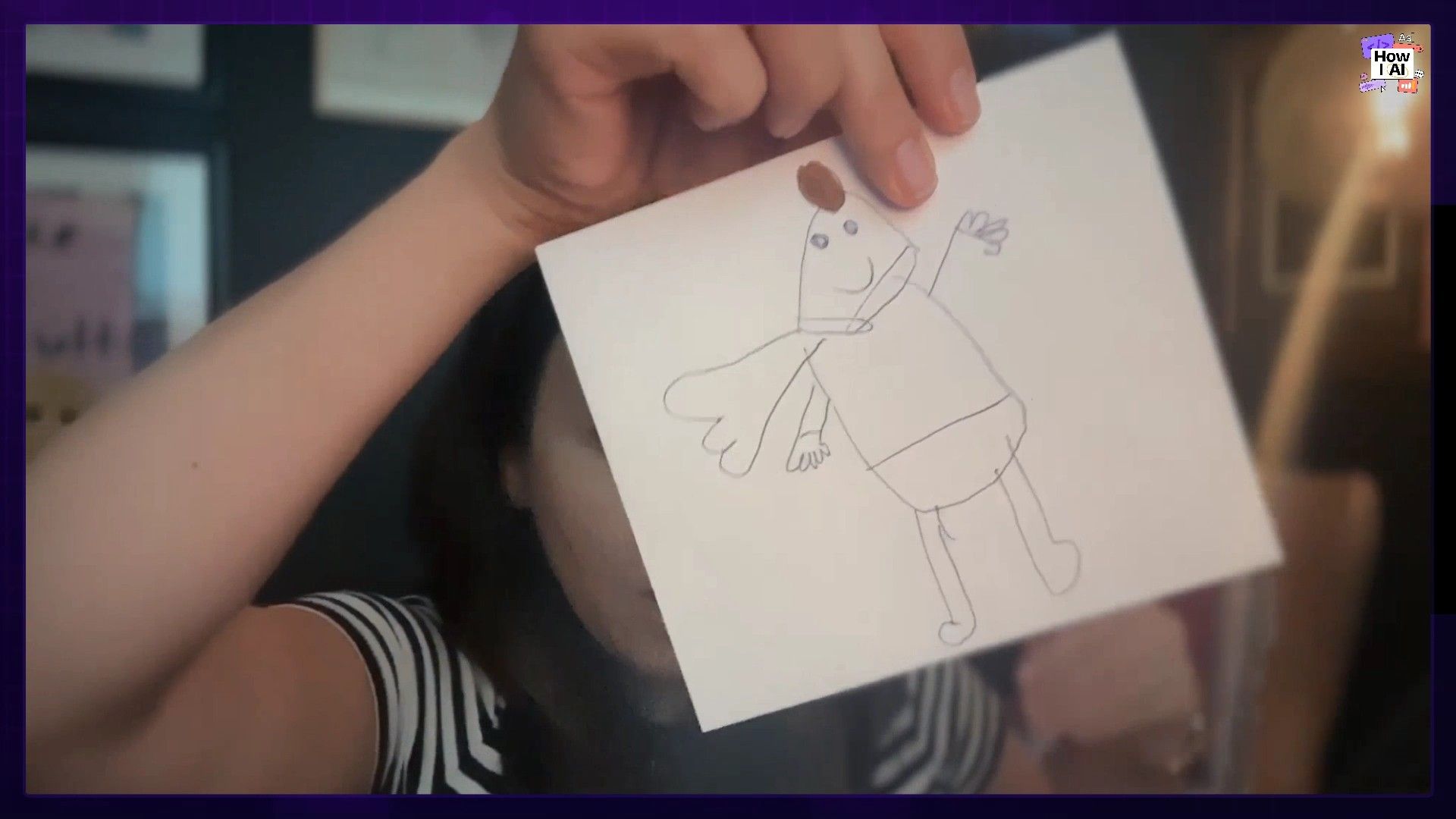 Claire holding up the child's drawing of a superhero to the camera