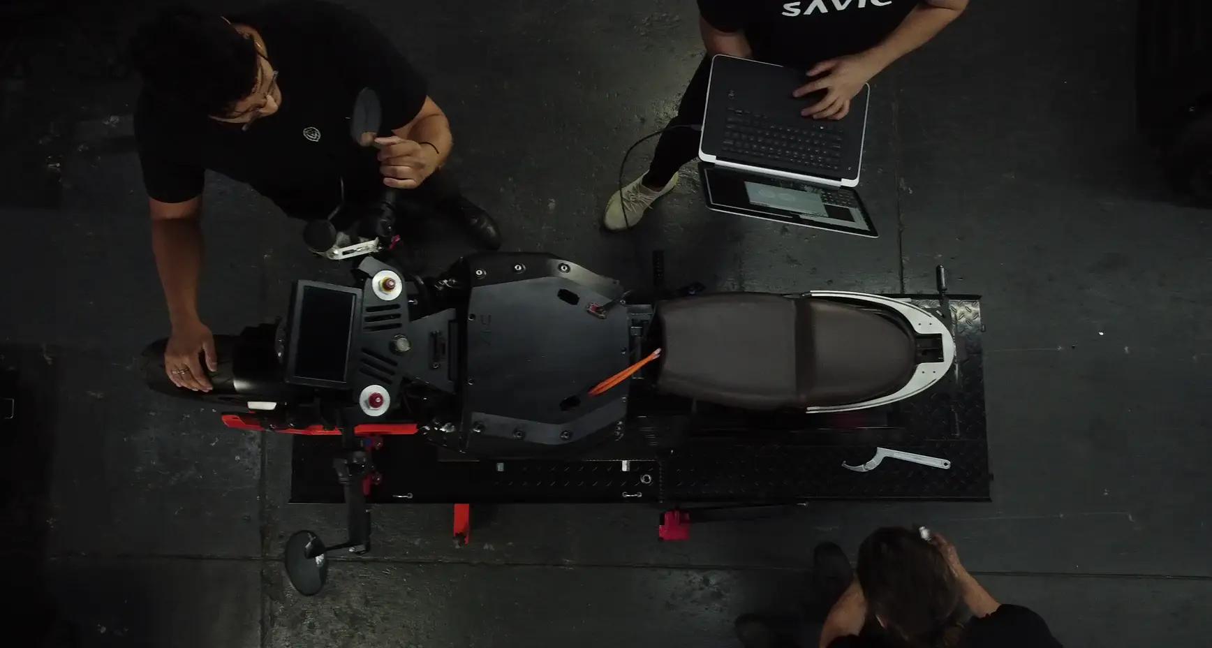 Overhead view of people working on motorcycle