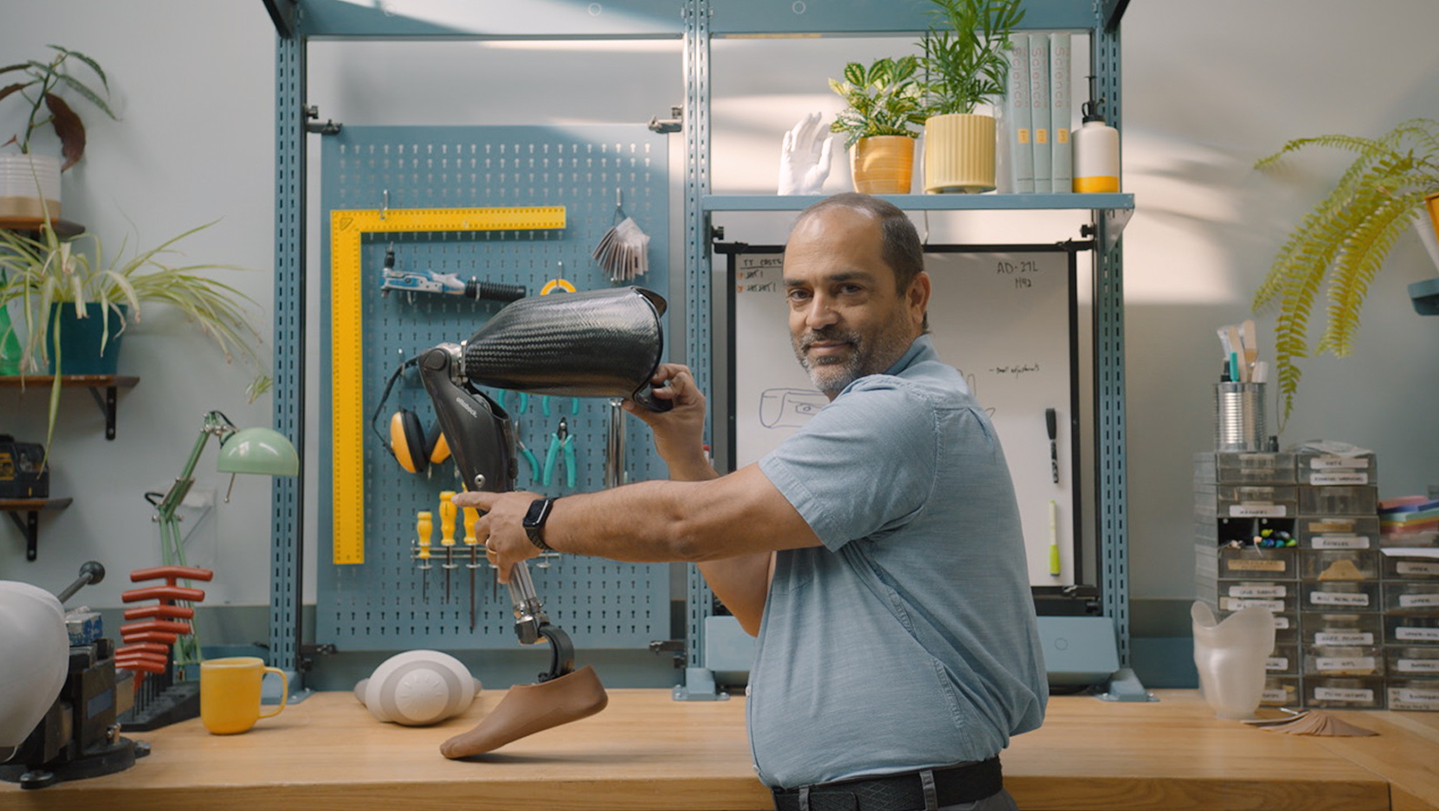 man fixes prosthetic leg