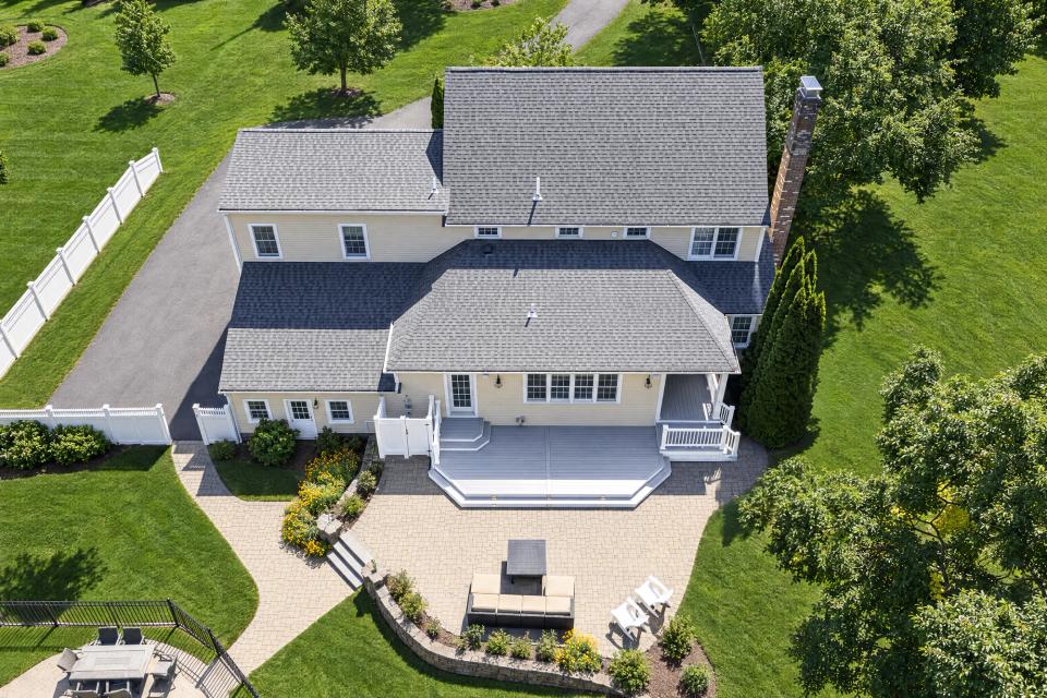 Aerial view of the grey backyard deck and surrounding patio in North Easton