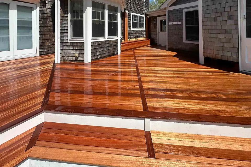 Mahogany deck levels joined by a wide step with a white riser and contrasting border boards