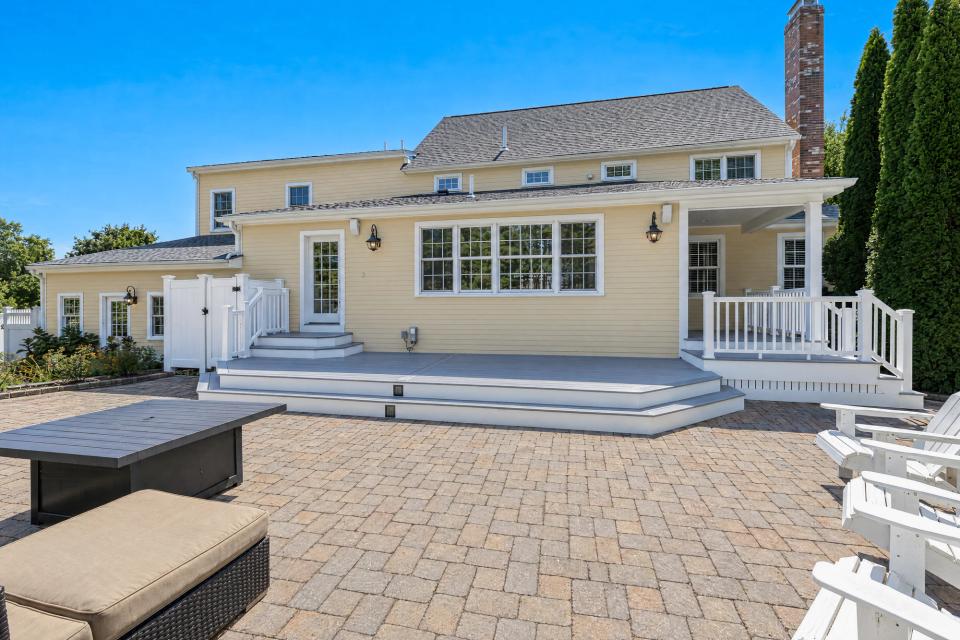 Ground-level view of the backyard deck and wraparound steps