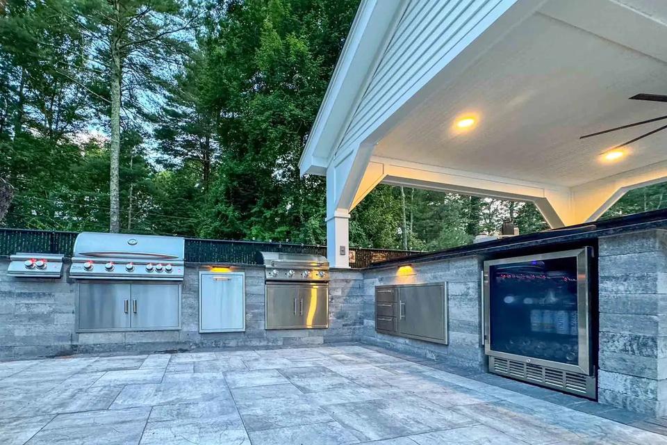 Built-in stainless steel grill and storage cabinets along the pavilion outdoor kitchen