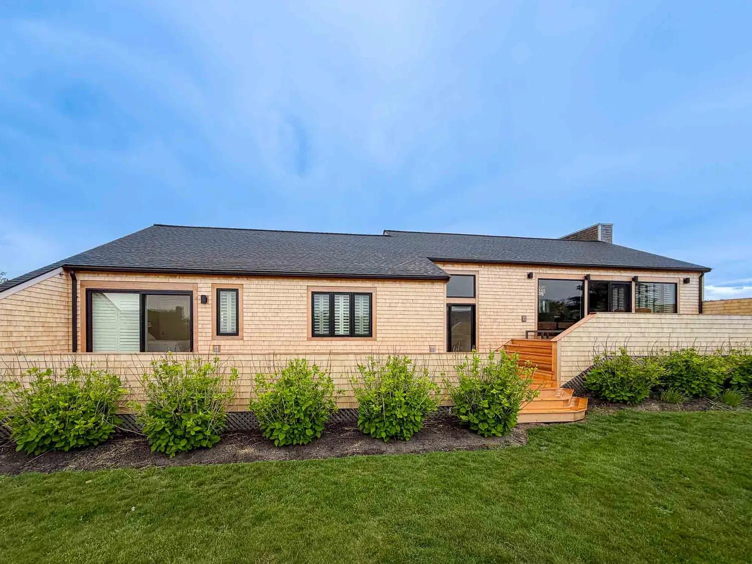 Cedar-shingled coastal home exterior with the new deck