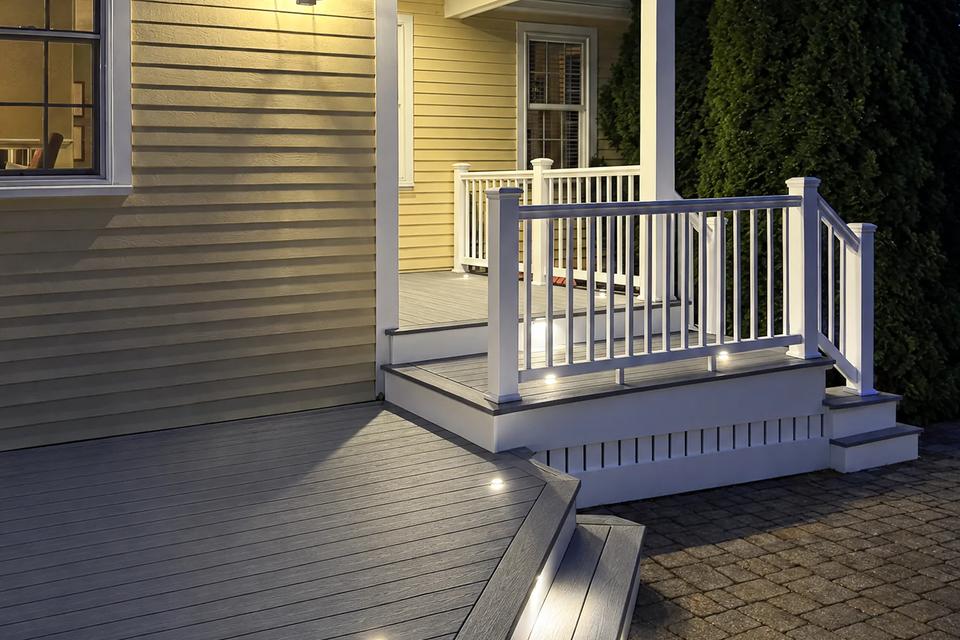 Portrait view of the lit porch landing and side stairs at night