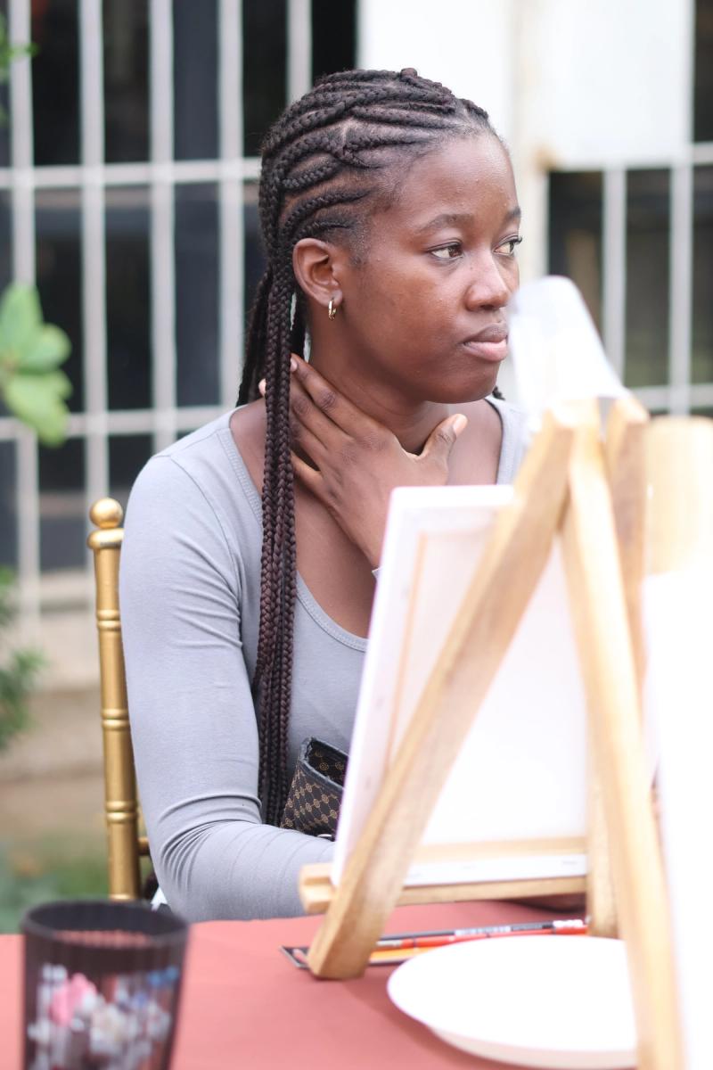 A Book For, A participant in the painting workshop.