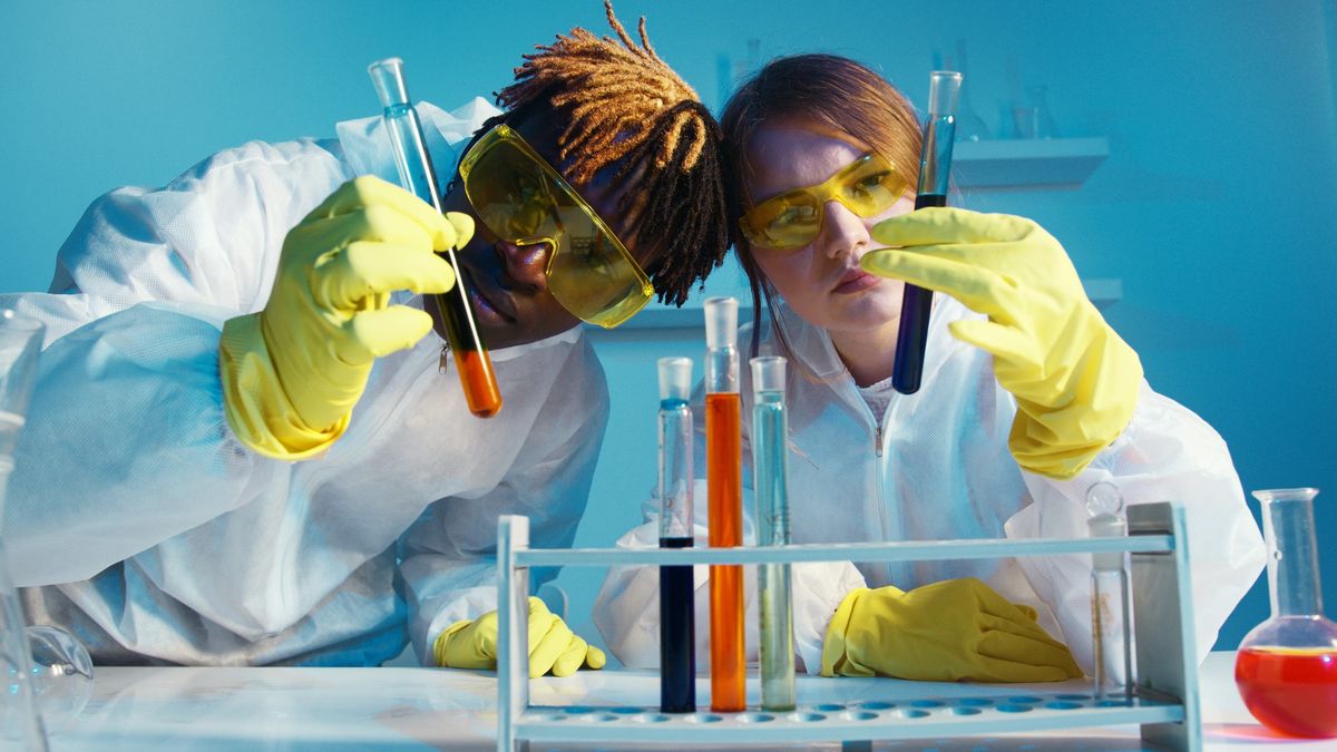 Scientists in a lab looking at test tubes