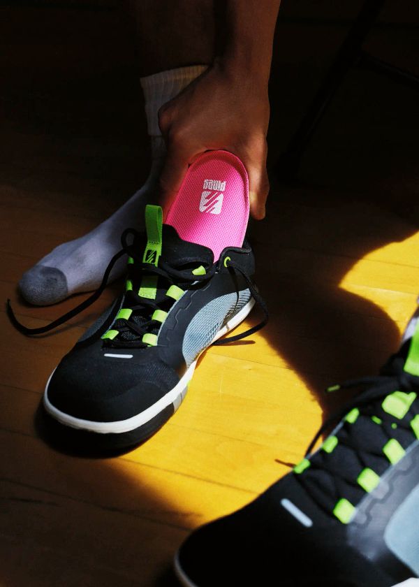 A player swapping an Alt-4 midsole into a pair of Atomic Court sneakers.  