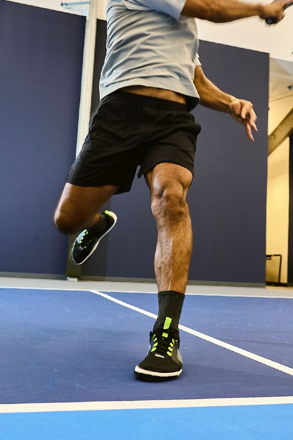 Man playing pickleball in a pair of Atomic Courts, Onyx Ecto colorway.