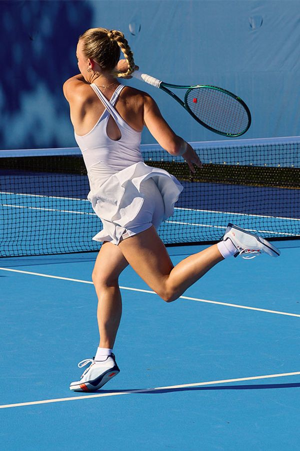 a tennis player backswing wearing a pair of Atomic Courts in the Arctic Flame colorway